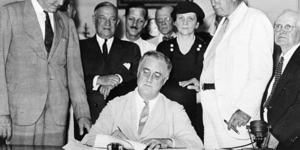 FDR with Frances Perkins Behind Him While Signing the Social Security Act