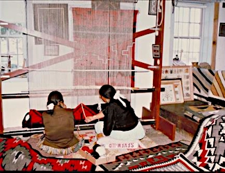 Navajo women weaving a rug